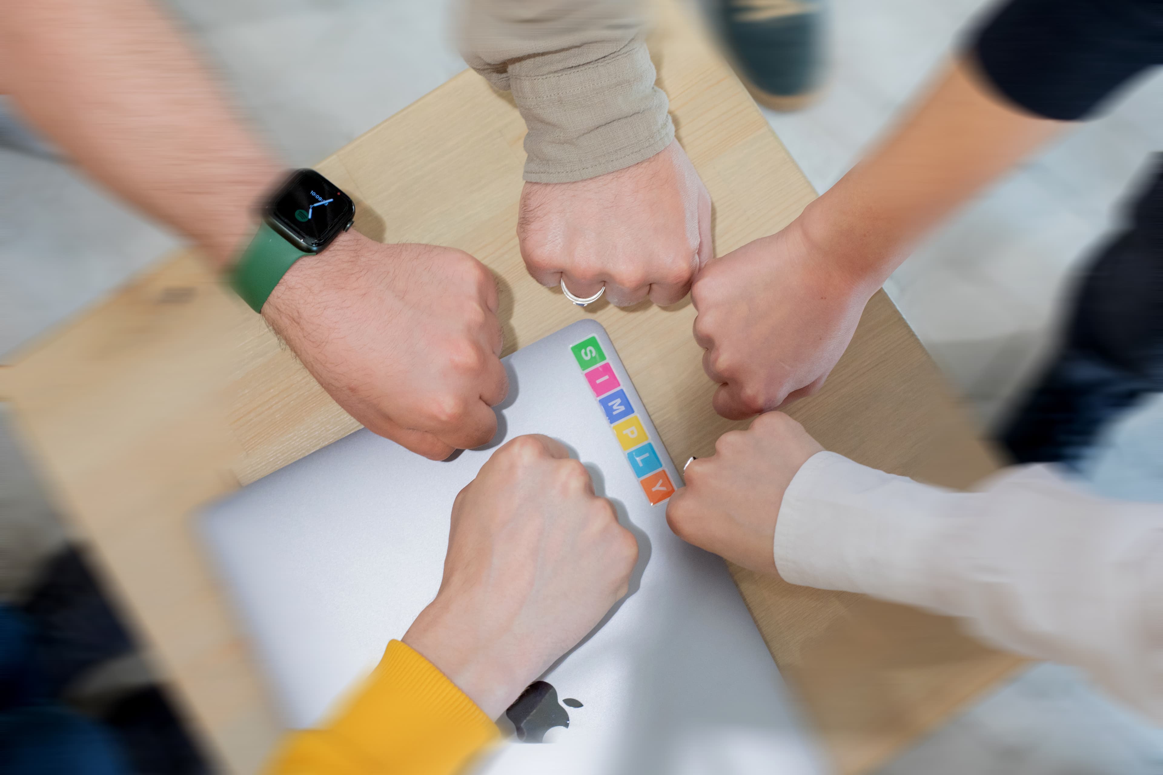 Hands together representing Simply Technologies team collaboration