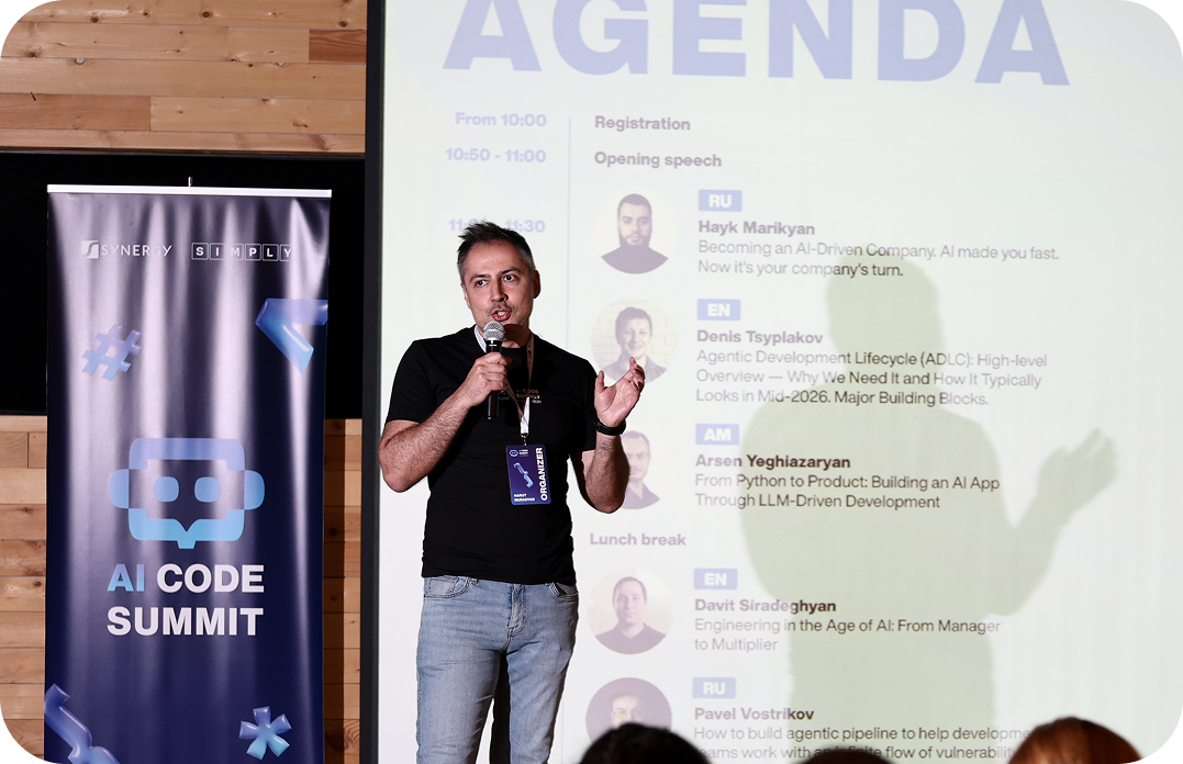 Speaker presenting the agenda at AI Code Summit
